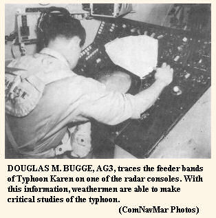 DOUGLAS M. BUGGE, AG3, traces the feeder bands of Typhoon Karen on one of the radar consoles.