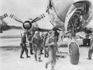 FIRST ELEMENTS of Mike Company, 3rd Battalion, 4th Marines debark at NAS on their mercy mission to Guam.